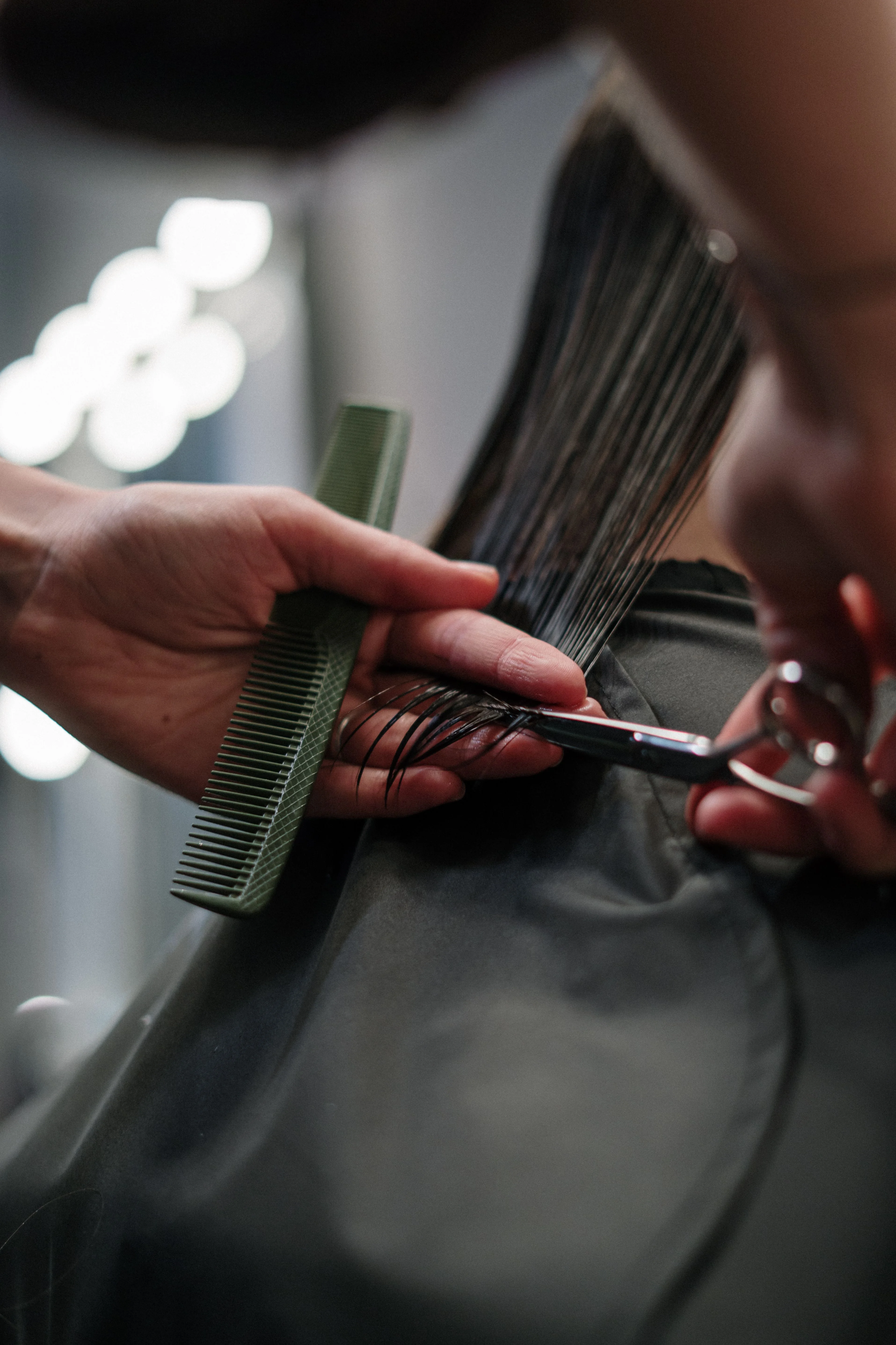 Stylist cutting and finishing a client's hair