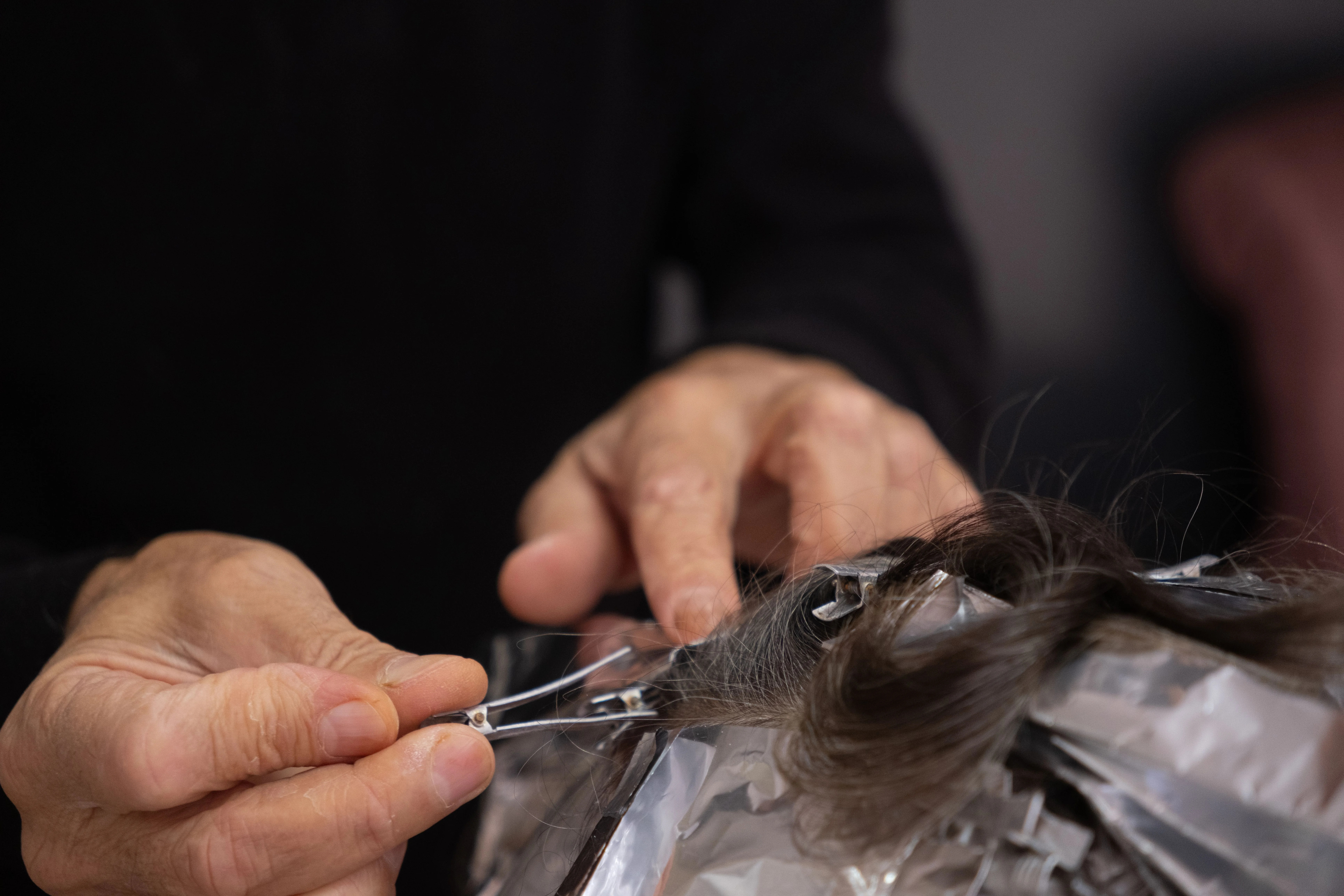 Hair extensions being fitted and blended