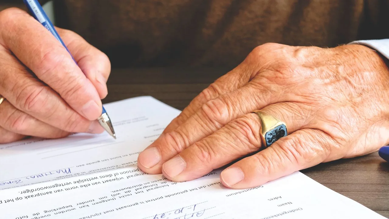 Senior adult signing estate and probate documents